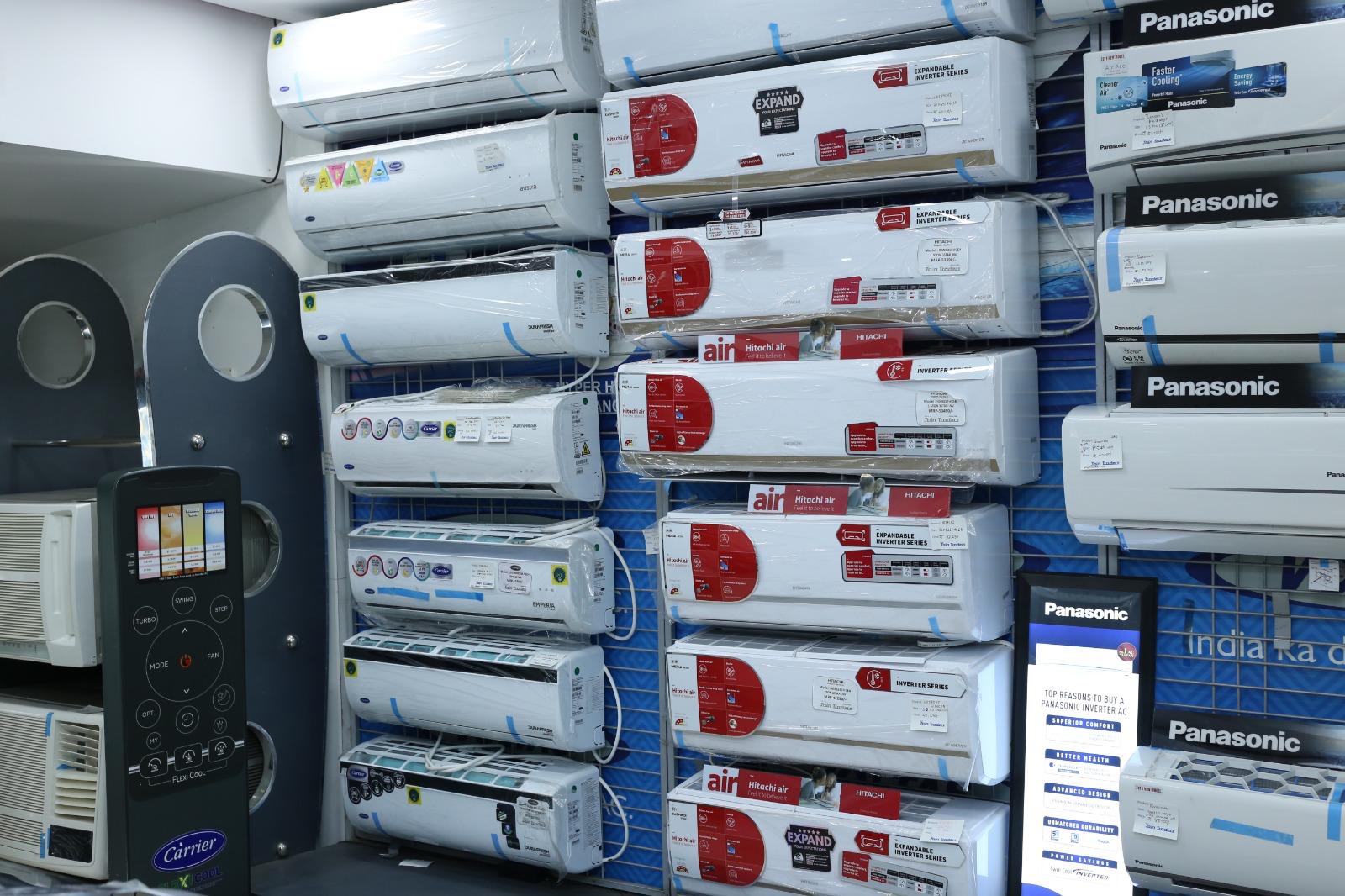 A Jain Traders team member helping a customer choose an appliance